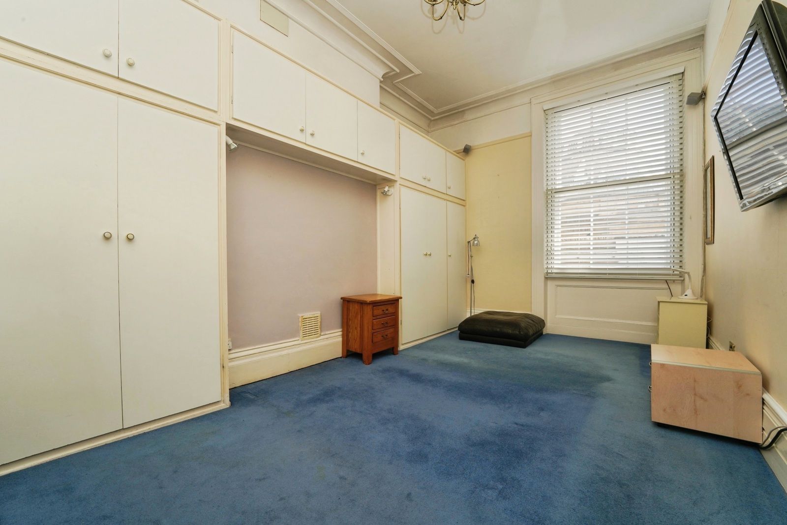 Bedroom with fitted wardrobes and overhead cupboards, unfurnished