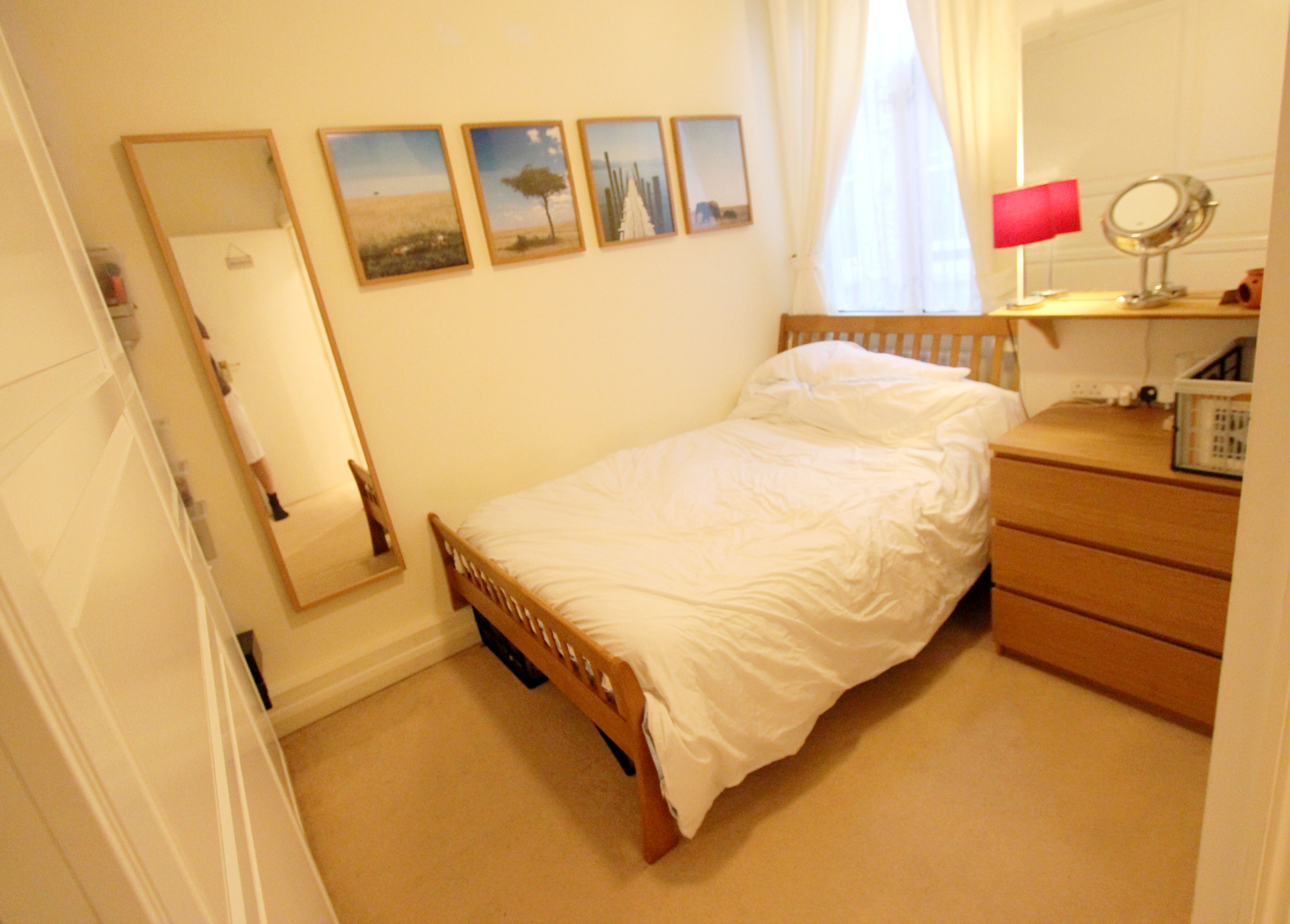 Double bedroom with bed, chest of drawers and a window to the rear